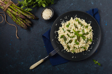 Classic Italian risotto with asparagus. Top view. Darkblue background.