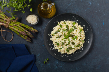 Classic Italian risotto with asparagus. Top view. Darkblue background.