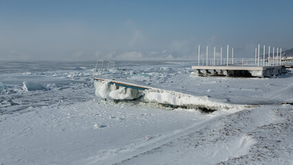 Pier covered with ice on Lake Baikal