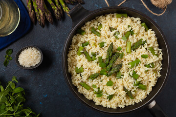 Classic Italian risotto with asparagus. Top view. Darkblue background.
