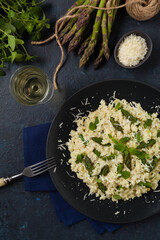 Classic Italian risotto with asparagus. Top view. Darkblue background.
