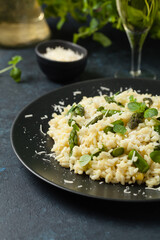 Classic Italian risotto with asparagus. Front view. Darkblue background.