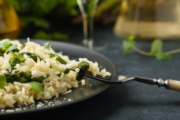 Classic Italian risotto with asparagus. Front view. Darkblue background.