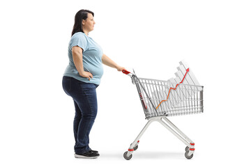 Casual woman standing with a shopping cart and a bar chart inside