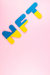NFT (Non-Fungible Token) in blue-yellow colors. NFT inscription on pink background. Top view. Copy space