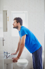 Time to face the day. Cropped shot of a young man standing in front of a bathroom mirror.