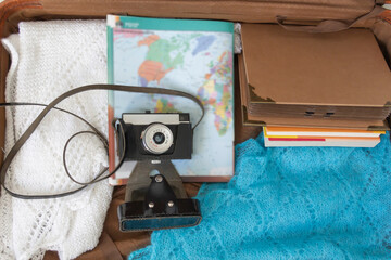 Old things folded in a retro suitcase for travel.