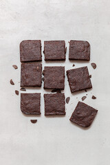 Slices of brownie dessert on a light background
