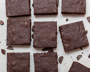 Slices of brownie dessert on a light background
