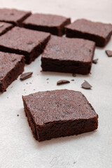 Slices of brownie dessert on a light background
