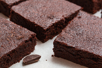 Slices of brownie dessert on a light background
