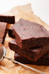 Slices of brownie dessert on a light background
