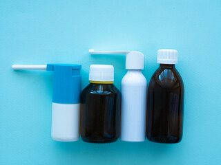 Dark brown glass medicine bottles with white caps and white inhaler bottles. Concept medicine and pharmacy. 