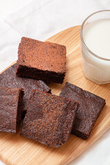 Slices of brownie dessert on a light background
