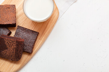 Slices of brownie dessert on a light background
