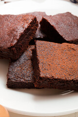 Slices of brownie dessert on a light background
