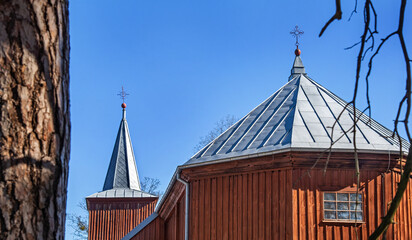 General view and close-up architectural details of the wooden Catholic church of Saint Matthew the Apostle built in 1849 in Jaminy in Podlasie, Poland.