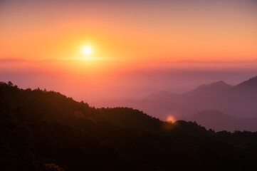 Fototapeta premium Sunrise over mountain with colorful sky in tropical rainforest at national park in the morning