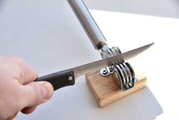 Sharpening an iron knife with a sharpener