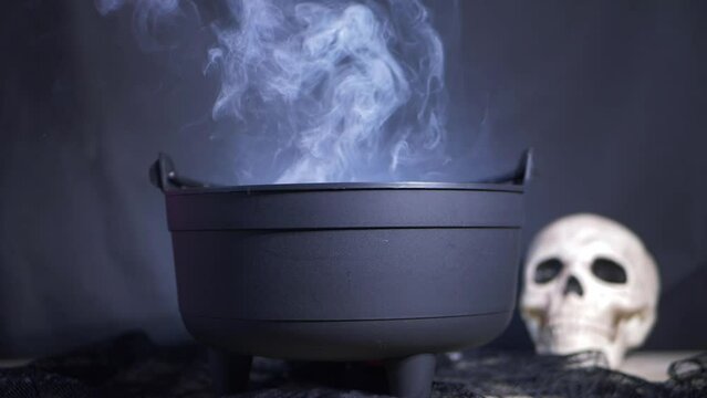 Halloween cauldron with spell potion brewing