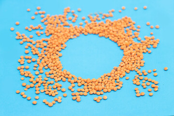 red lentils pile or masoor dhal isolated on blue background,