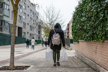 Naklejka premium Woman returns home with shopping bags