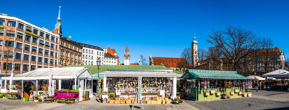 Munich, Germany - March 8: typical stands and pedestrians at the famous viktualienmarkt in Munich on March 8, 2022