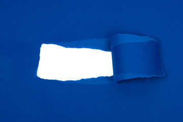 Blue crushed torn paper with hole copyspace background for idea