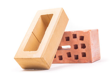 white background. the brick was made of clay. there are holes. close-up.