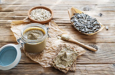 Homemade sunflower seed spread - sunbutter with seeds on a wooden background