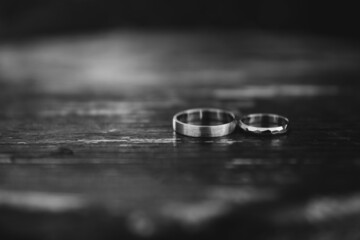 Obraz na płótnie Canvas Modern wedding jewelry. Closeup of two golden wedding rings on wooden background.