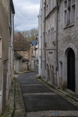 Fototapeta na wymiar Chablis, France - February 23, 2022: Chablis is a town in the Bourgogne-Franche-Comte famous for its french white wine. Cloudy winter day. Selective focus.