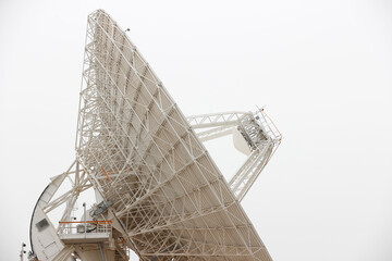 satellite dish radar antenna station in field. parabolic antennas. Big parabolic antenna against sky. Satellite dish at earth station with a sky.