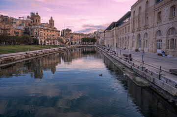 Fototapeta premium Sunset over small canal in Cospicua, Malta