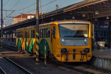 Prague main station in sunny winter evening with trains