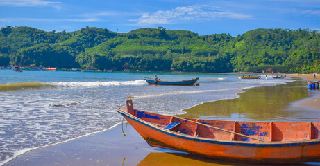 Traditional wooden fishing boats and beautiful hilly beach in East Java province, Indonesia.
boat...