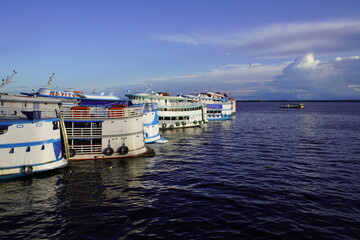 Fototapeta na wymiar Amazon boats in the late afternoon in the port of Manaus Amazonas, Brazil 