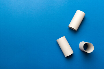 Flat lay composition with empty toilet paper rolls and space for text on color background. Recyclable paper tube with metal plug end made of kraft paper or cardboard