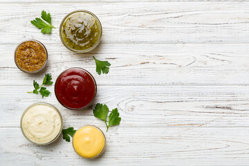 Many different sauces and herbs on table, flat lay top view. sauces with spices healthy concept