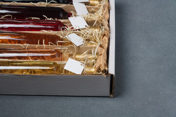 Fototapeta premium Assortment of 250 ml no label bottles of red, pink, white wine in box. Set of alcohol drinks for present or celebration. Close up, copy space