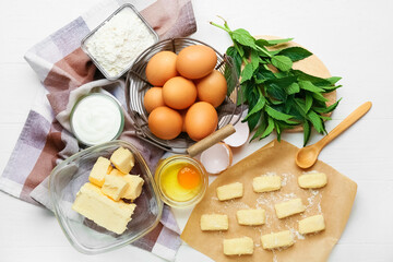 Composition with ingredients for preparing lazy dumplings on light wooden background