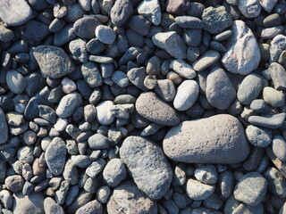 a pile of small stones on the lake