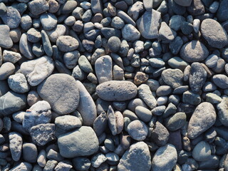 a pile of small stones on the lake