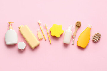 Set of cosmetic products and different bath accessories on pink background