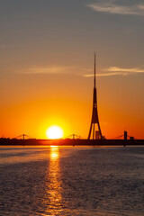 Beautiful sunset in Riga, Latvia. Daugava river. The bright sky above the water.