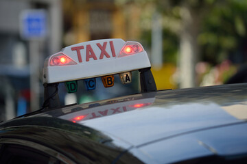 taxi sign on a black car in france - obrazy, fototapety, plakaty