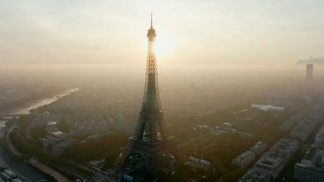 Aerial Panorama of Paris Cityscape with Eiffel Tower and Seine River. Landmark Monument of Capital of France and Popular Touristic Destination. Travel and Urban Skyline View. 4K drone zoom out shot
