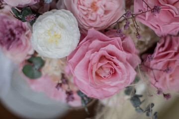 Peonies and pink roses in a grey box on background of the armchair. Bouquet of pink peonies a girl for mother's day, valentine's day, Woman's day 8 march. White interior.