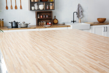 Empty wooden table top in light kitchen, closeup