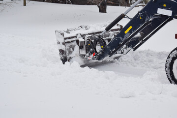 Tractor cleaning snow